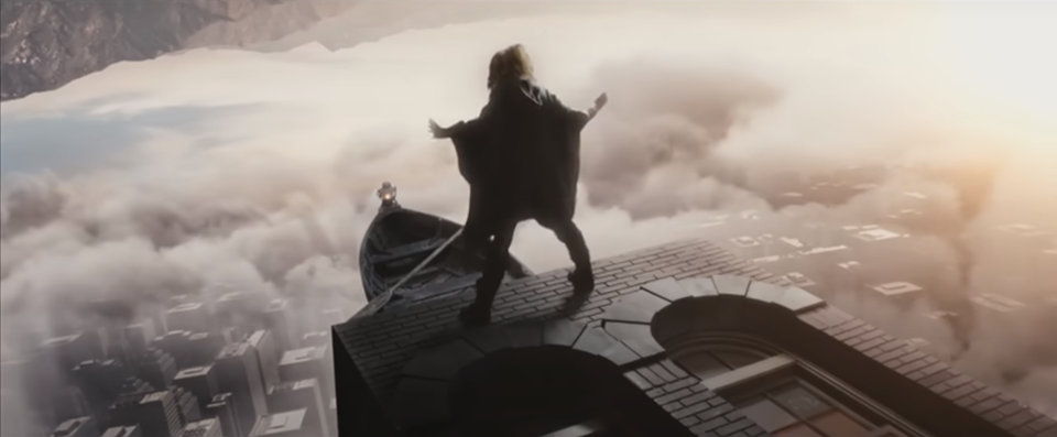 Image from Lindsey Stirling's Take Flight music video, girl standing on edge of building with boat on clouds in front of her